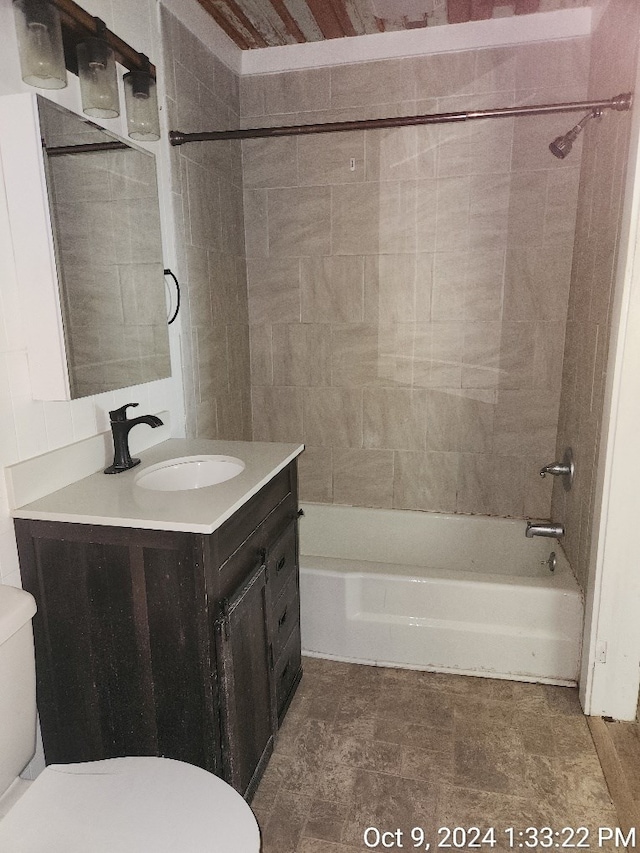 full bathroom featuring vanity, toilet, and tiled shower / bath combo