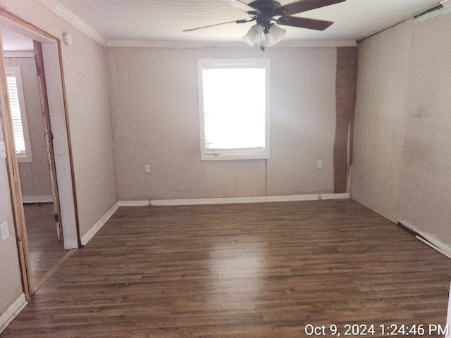 empty room with dark hardwood / wood-style flooring, ceiling fan, and ornamental molding