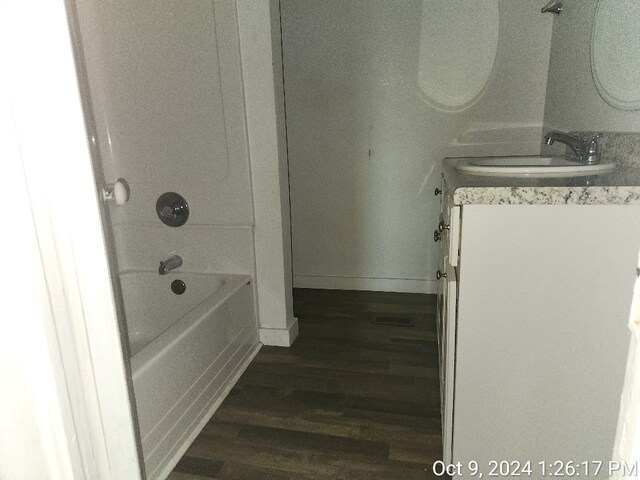bathroom featuring shower / bath combination, vanity, and hardwood / wood-style flooring