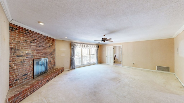 709 Rosemont Dr, Dothan, AL 36303 - unfurnished living room with visible vents, crown molding, carpet, a fireplace, and a textured ceiling