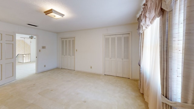 709 Rosemont Dr, Dothan, AL 36303 - unfurnished bedroom with visible vents, light colored carpet, baseboards, and multiple closets