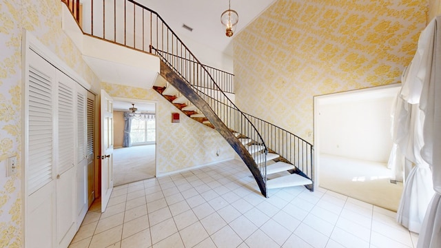 709 Rosemont Dr, Dothan, AL 36303 - stairway with visible vents, carpet, a high ceiling, wallpapered walls, and baseboards