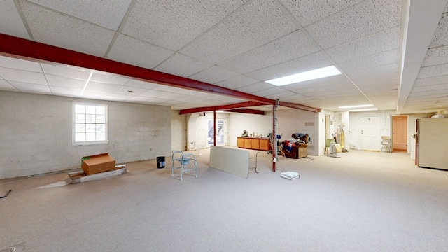 709 Rosemont Dr, Dothan, AL 36303 - below grade area featuring a drop ceiling, concrete block wall, and freestanding refrigerator