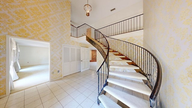 709 Rosemont Dr, Dothan, AL 36303 - staircase featuring wallpapered walls, tile patterned floors, visible vents, and a towering ceiling
