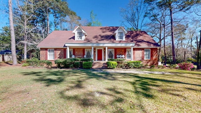 709 Rosemont Dr, Dothan, AL 36303 - cape cod house with brick siding, a porch, and a front yard