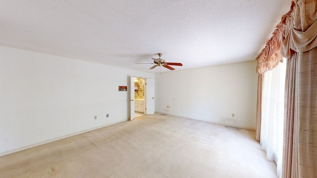 709 Rosemont Dr, Dothan, AL 36303 - spare room with light colored carpet, a ceiling fan, and a textured ceiling