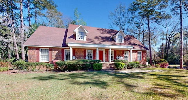 709 Rosemont Dr, Dothan, AL 36303 - cape cod-style house featuring brick siding, a porch, and a front yard