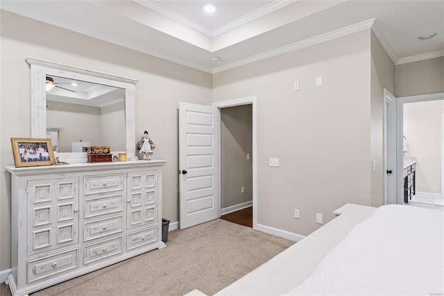 bedroom featuring carpet flooring, a raised ceiling, and ornamental molding