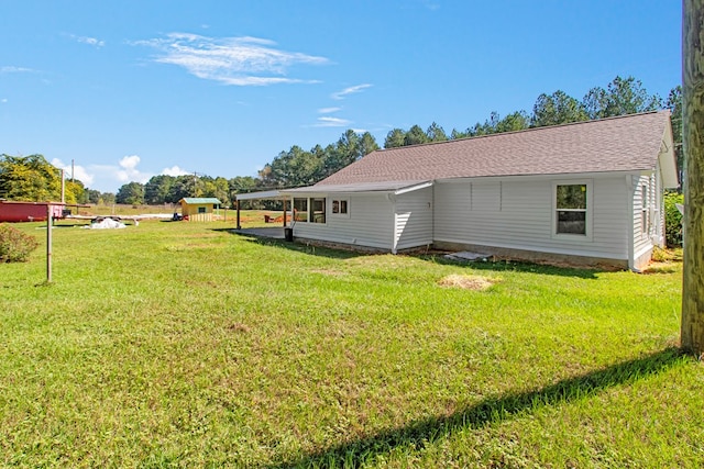 view of property exterior with a yard and a carport