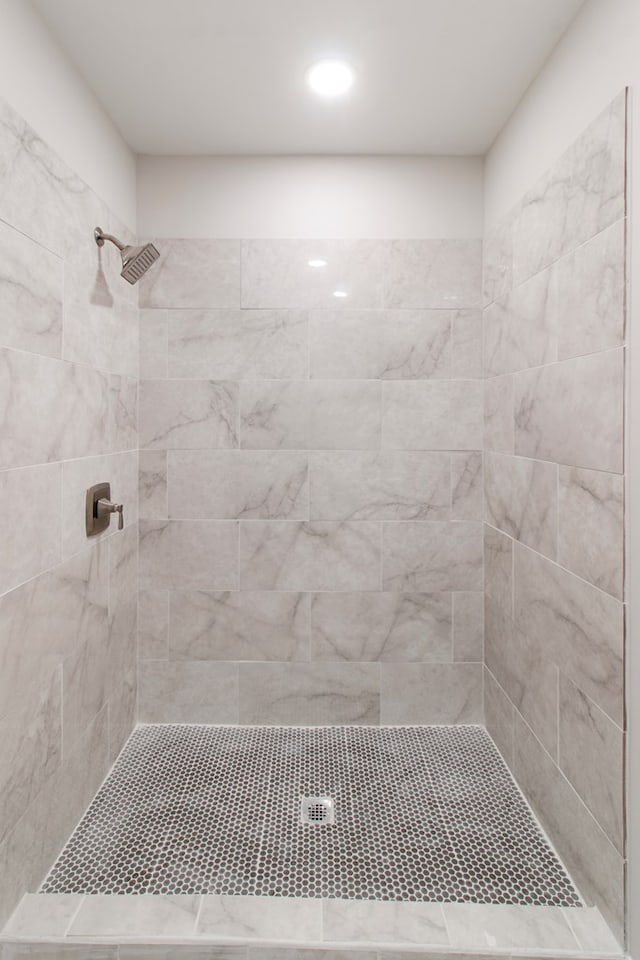 bathroom with tiled shower