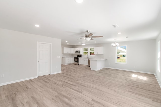 unfurnished living room with sink, light hardwood / wood-style floors, and ceiling fan with notable chandelier