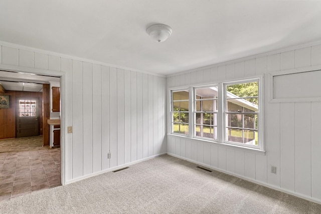 1105 Deborah St, Dothan, AL 36301 - carpeted empty room featuring ornamental molding and wood walls