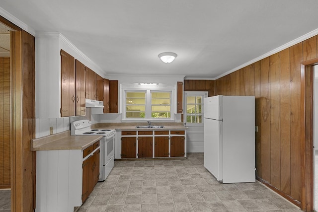 1105 Deborah St, Dothan, AL 36301 - kitchen with white appliances, under cabinet range hood, light countertops, wooden walls, and crown molding