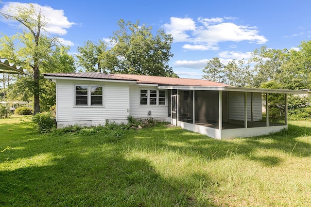 1105 Deborah St, Dothan, AL 36301 - rear view of house with a sunroom, a yard, and a metal roof