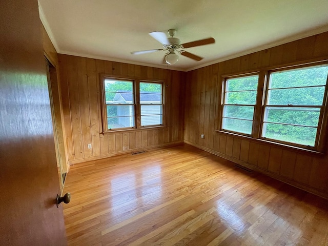 1105 Deborah St, Dothan, AL 36301 - spare room with light wood-style floors, crown molding, ceiling fan, and wooden walls