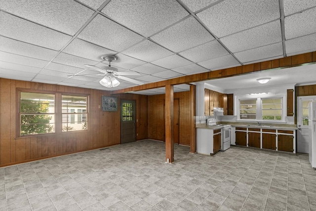 1105 Deborah St, Dothan, AL 36301 - kitchen featuring white appliances, light countertops, wooden walls, ceiling fan, and under cabinet range hood