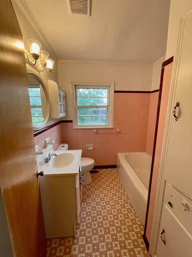 1105 Deborah St, Dothan, AL 36301 - bathroom with tile patterned floors, healthy amount of natural light, vanity, tile walls, and a tub