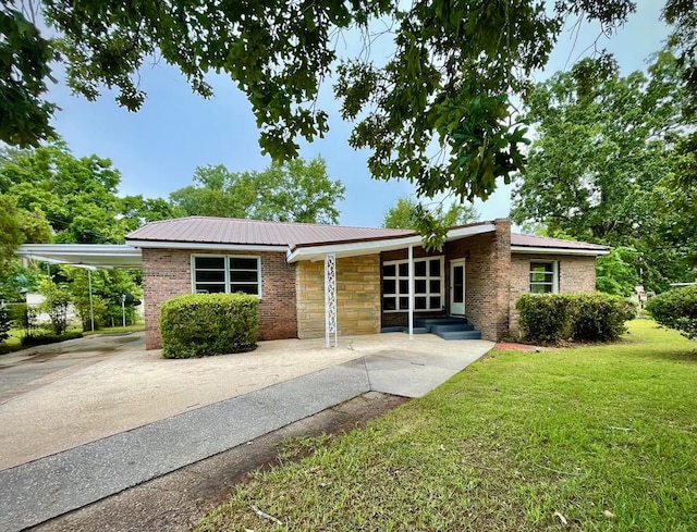 1105 Deborah St, Dothan, AL 36301 - view of front of house featuring a front lawn, a metal roof, brick siding, and a carport