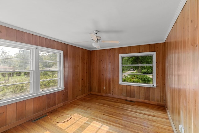 1105 Deborah St, Dothan, AL 36301 - empty room with light wood-type flooring, a ceiling fan, and wood walls