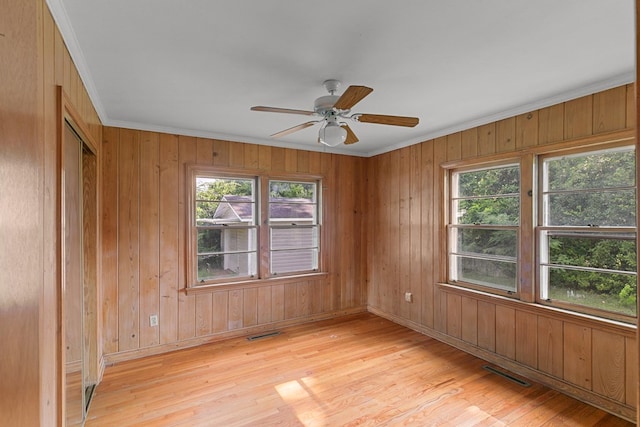 1105 Deborah St, Dothan, AL 36301 - unfurnished room featuring crown molding, light wood finished floors, ceiling fan, and wood walls