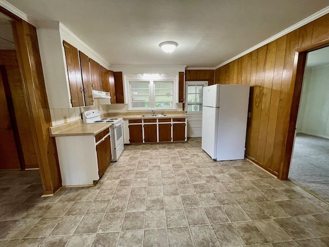 1105 Deborah St, Dothan, AL 36301 - kitchen featuring white appliances, under cabinet range hood, wood walls, ornamental molding, and light countertops