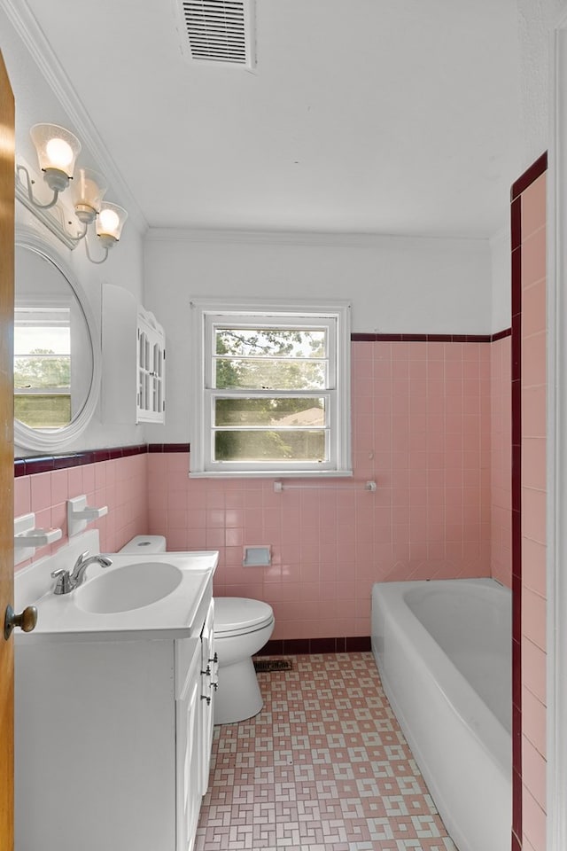 1105 Deborah St, Dothan, AL 36301 - bathroom with plenty of natural light, vanity, tile walls, a bathtub, and tile patterned floors