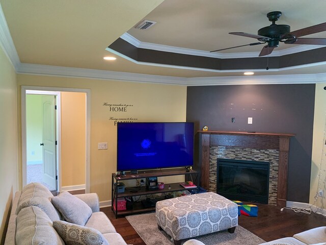 708 Sandstone Dr, Dothan, AL 36303 - living room with a tray ceiling, wood finished floors, a fireplace, ceiling fan, and crown molding