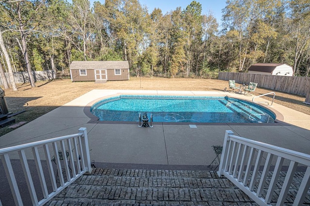 view of pool with an outbuilding and a patio area