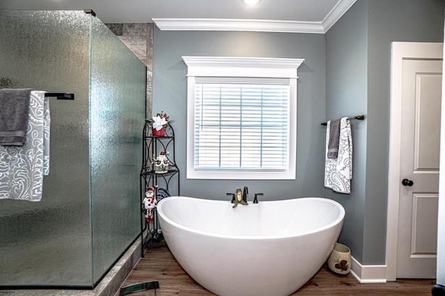 bathroom with plus walk in shower, hardwood / wood-style flooring, and ornamental molding