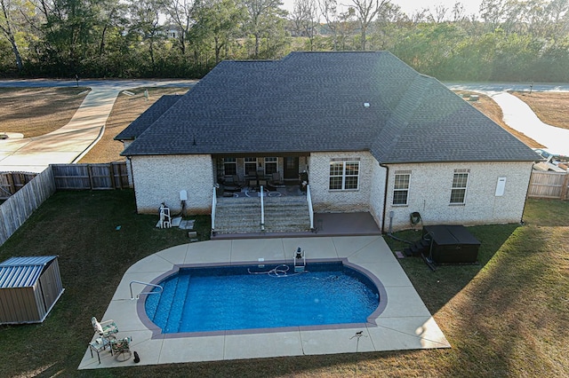 view of swimming pool featuring a yard and a patio area