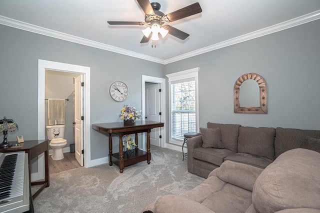 living room with ceiling fan, light colored carpet, and ornamental molding