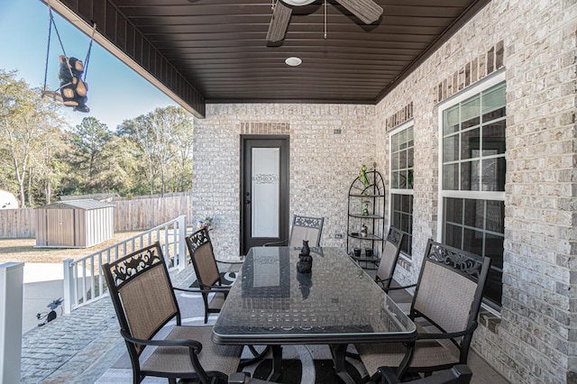 view of patio with a storage unit and ceiling fan