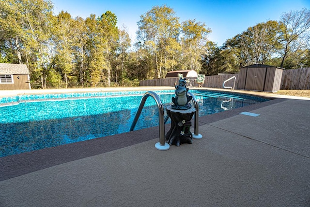 view of swimming pool featuring a shed