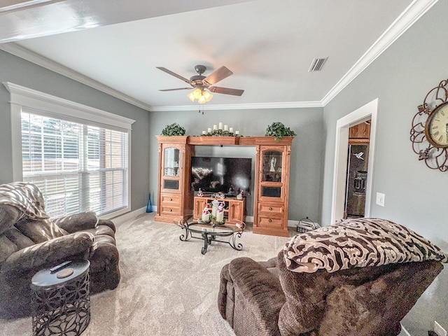 carpeted living room with ceiling fan and crown molding