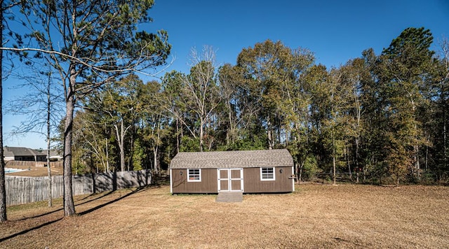 view of outbuilding featuring a lawn