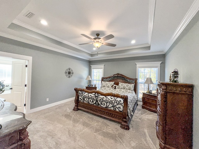 bedroom with light carpet, a raised ceiling, multiple windows, and ceiling fan