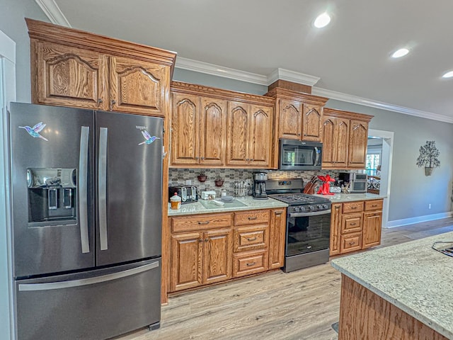 kitchen featuring tasteful backsplash, light hardwood / wood-style flooring, ornamental molding, and appliances with stainless steel finishes