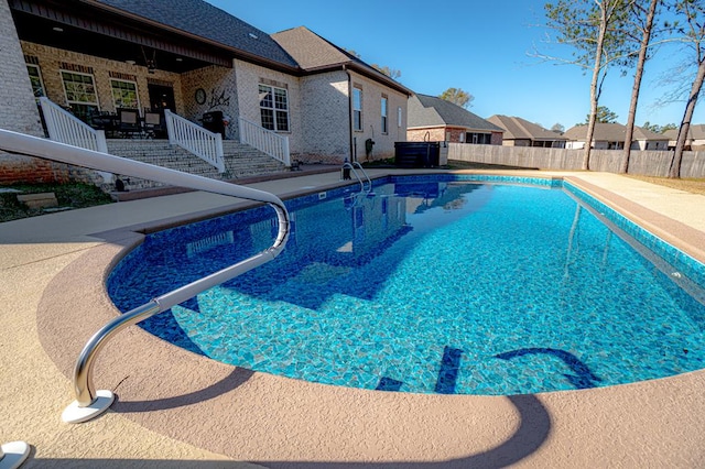 view of pool featuring ceiling fan and a patio area