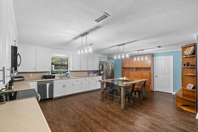 6970 Walden Dr, Kinsey, AL 36303 - kitchen with appliances with stainless steel finishes, dark wood-type flooring, light countertops, and a textured ceiling