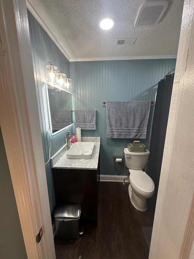 6970 Walden Dr, Kinsey, AL 36303 - full bathroom with crown molding, wood finished floors, vanity, a textured ceiling, and curtained shower