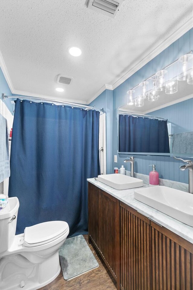 6970 Walden Dr, Kinsey, AL 36303 - bathroom with a textured ceiling, crown molding, wood finished floors, double vanity, and curtained shower