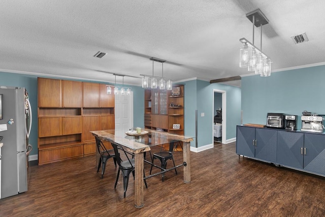 6970 Walden Dr, Kinsey, AL 36303 - dining area with dark wood-style floors, crown molding, and a textured ceiling