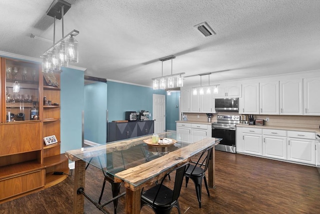 6970 Walden Dr, Kinsey, AL 36303 - dining area with dark wood-style floors, crown molding, and a textured ceiling
