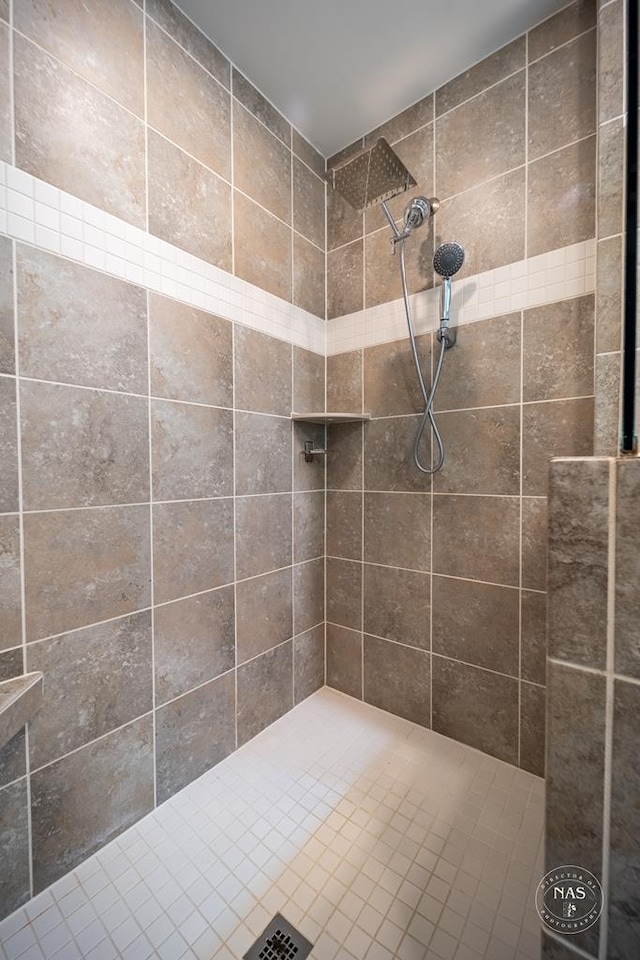 bathroom with a tile shower