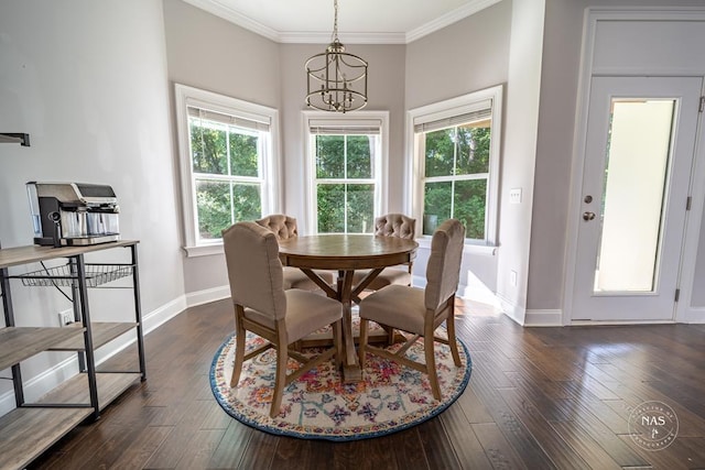 dining area with a healthy amount of sunlight, ornamental molding, dark wood-type flooring, and an inviting chandelier