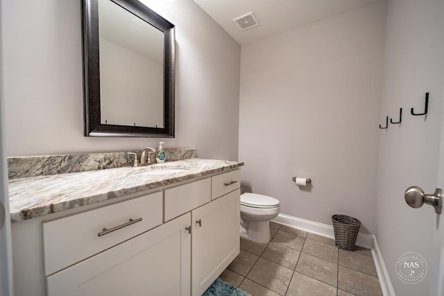 bathroom with tile patterned floors, vanity, and toilet