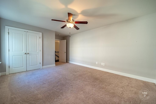 unfurnished bedroom featuring carpet, a closet, and ceiling fan