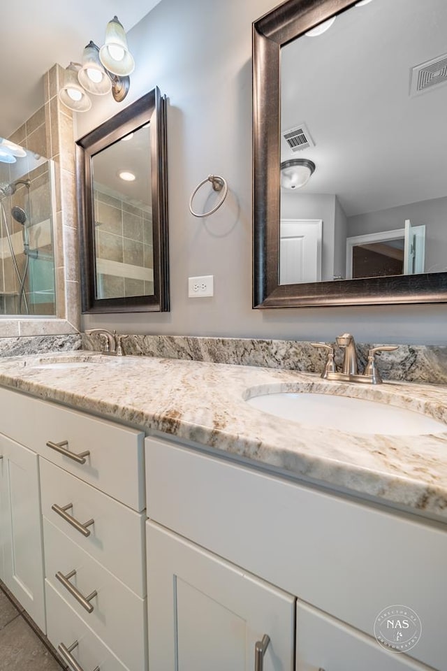 bathroom with vanity and a shower with shower door