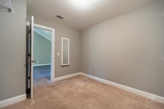 unfurnished room featuring light carpet