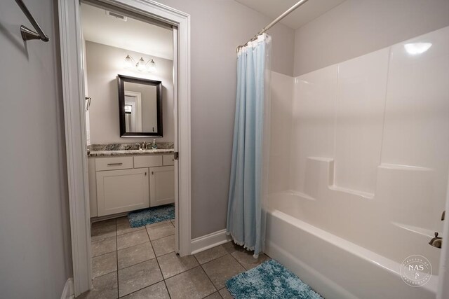 bathroom featuring tile patterned floors, vanity, and shower / bath combo